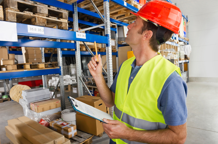 Manual worker with clipboard in warehouse